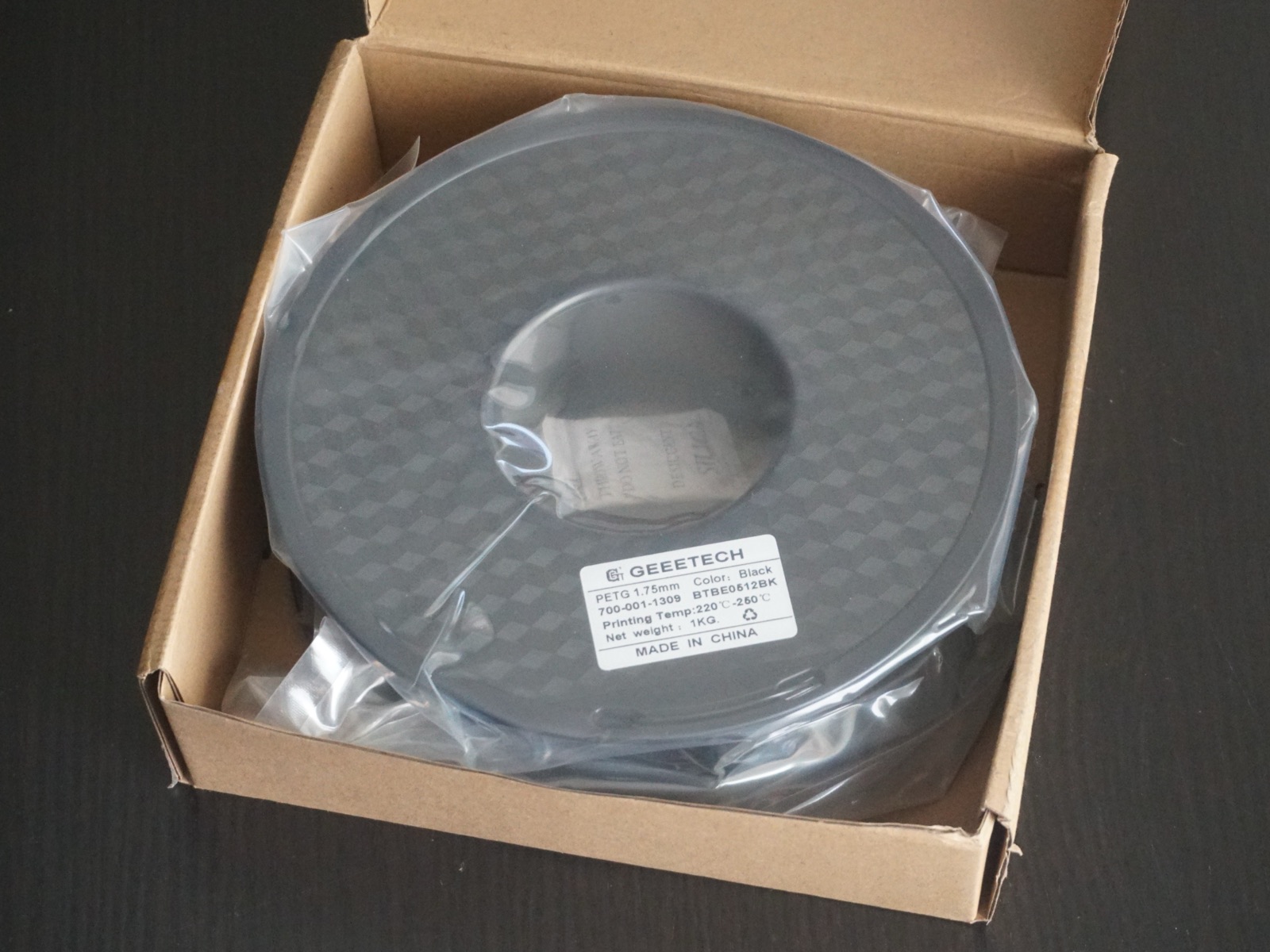 A spool of PETG filament in its packaging.